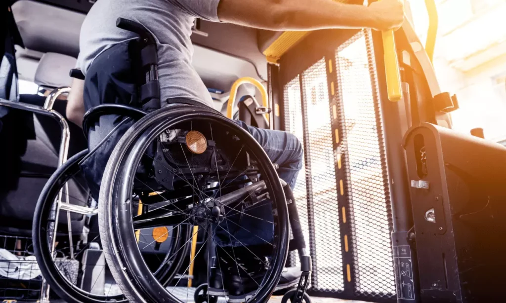 Man in wheelchair on bus waiting to exit